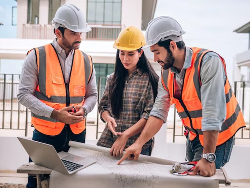 civil-engineer-construction-worker-architects-wearing-hardhats-safety-vests-are-working-together-construction-site-building-home-cooperation-teamwork-concept_640221-172-min011-min